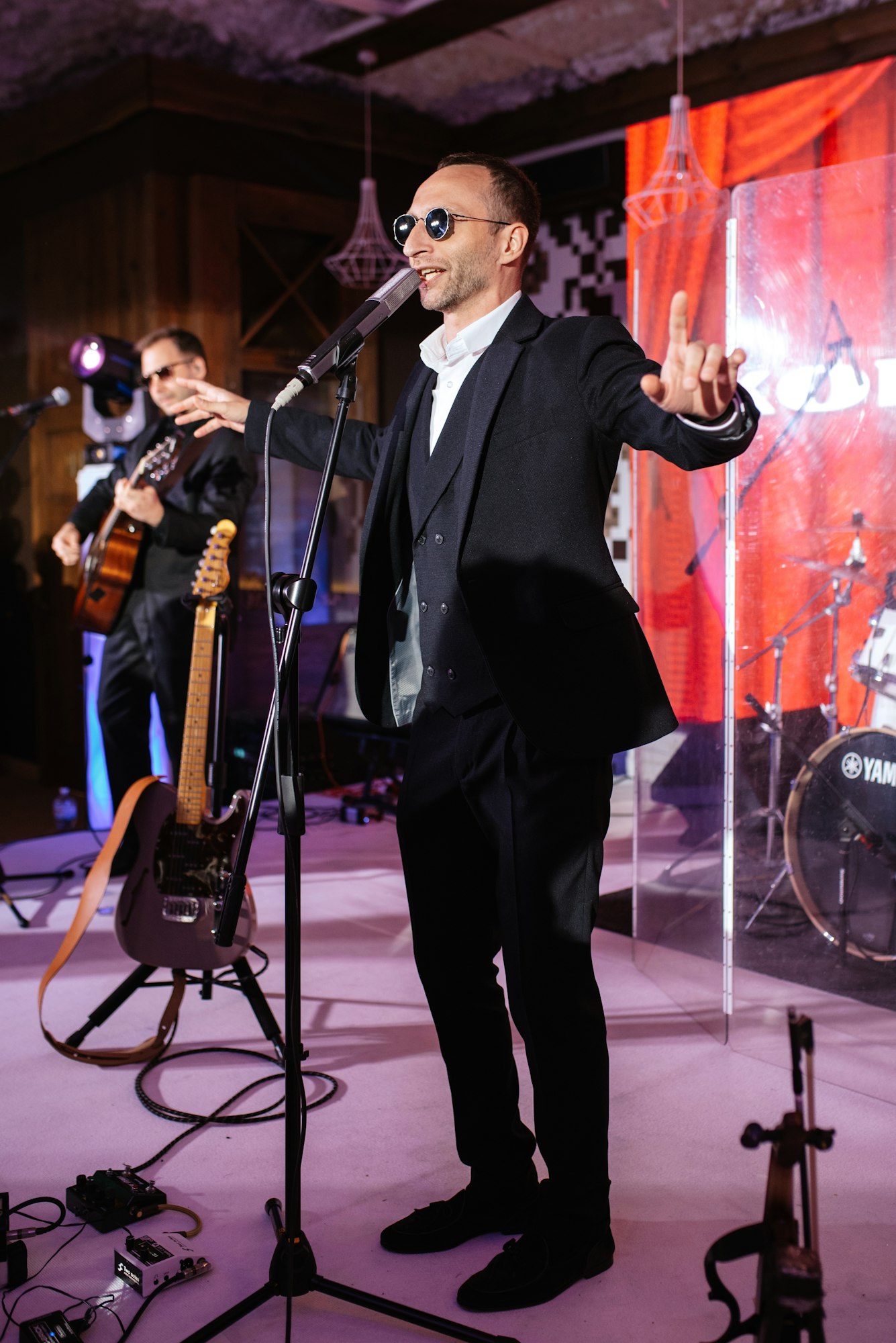 soloist on stage at a concert singing into a microphone