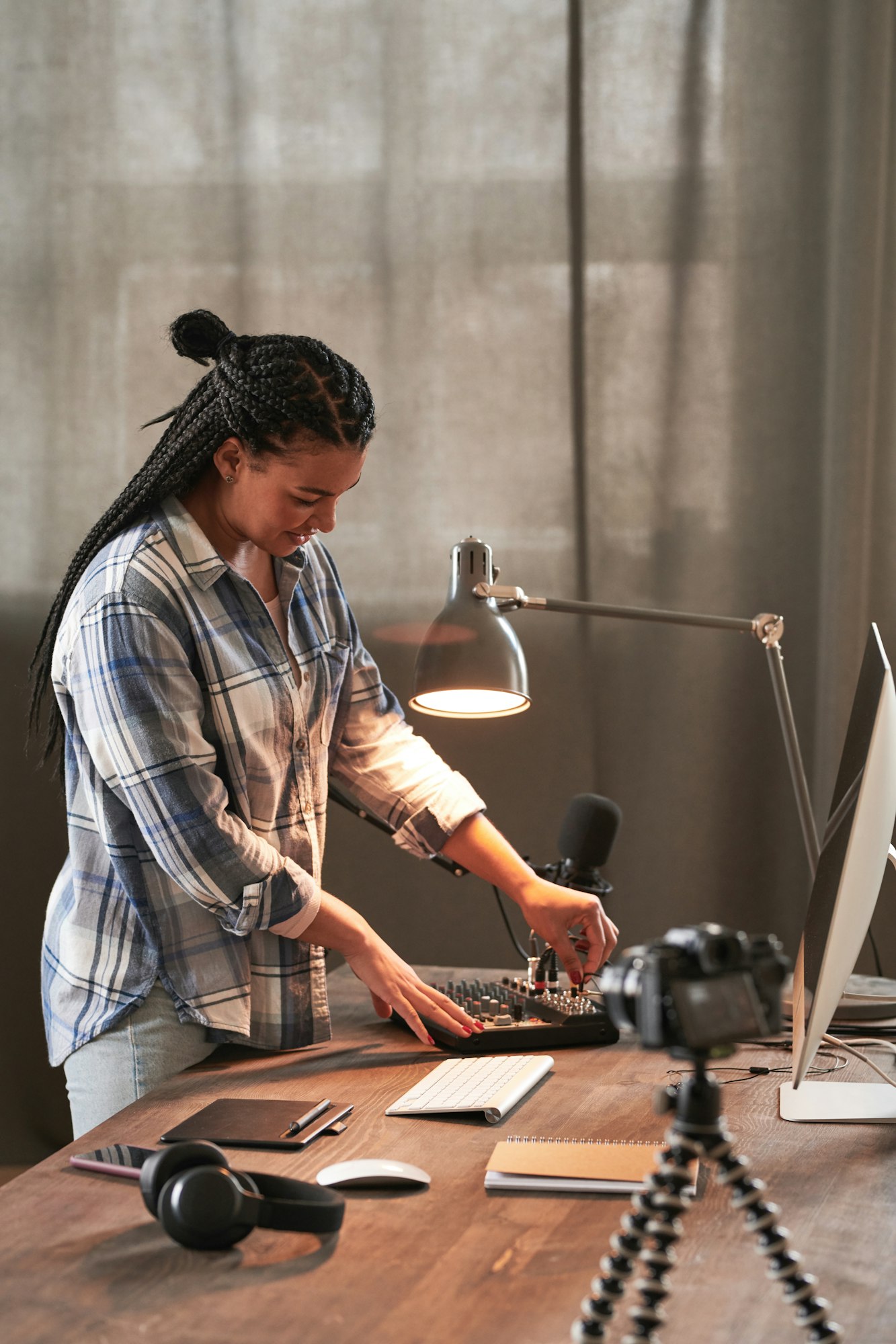 Young Woman Turning On Microphone For Streaming